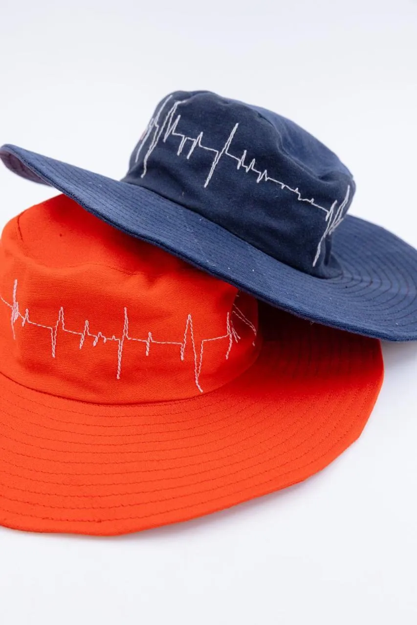 Navy and orange bucket hats with heartbeat embroidery